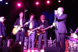 R.E.M. carefully avoids actual reunion as all 4 members play Peter Buck’s wedding