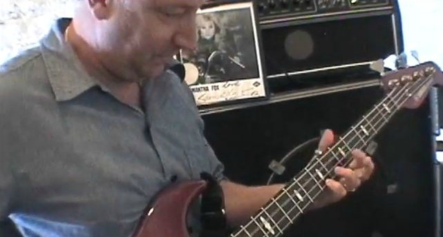 Video: Peter Hook schools interviewer on how to play ‘Love Will Tear Us Apart’ on bass